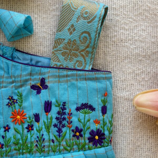 One shoulder design detail of kids festive frock