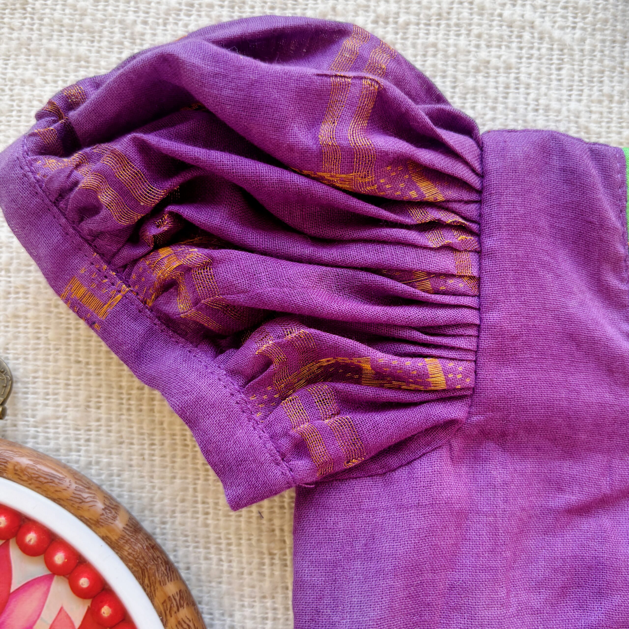 Puff sleeve detail of purple kids festive frock