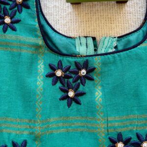 Close up embroidery work on kids festive frock