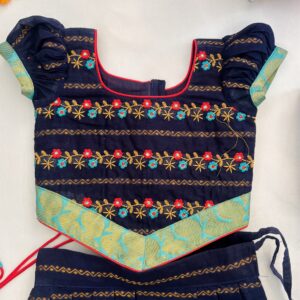 Top view close up of embroidered neckline on navy blue kids frock