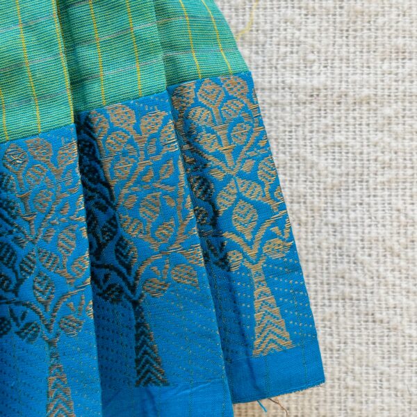 Blue zari border detail of green kids frock