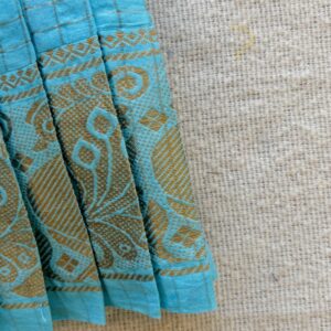 Traditional zari border detail of teal kids frock