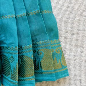 Traditional zari border detail of teal kids frock