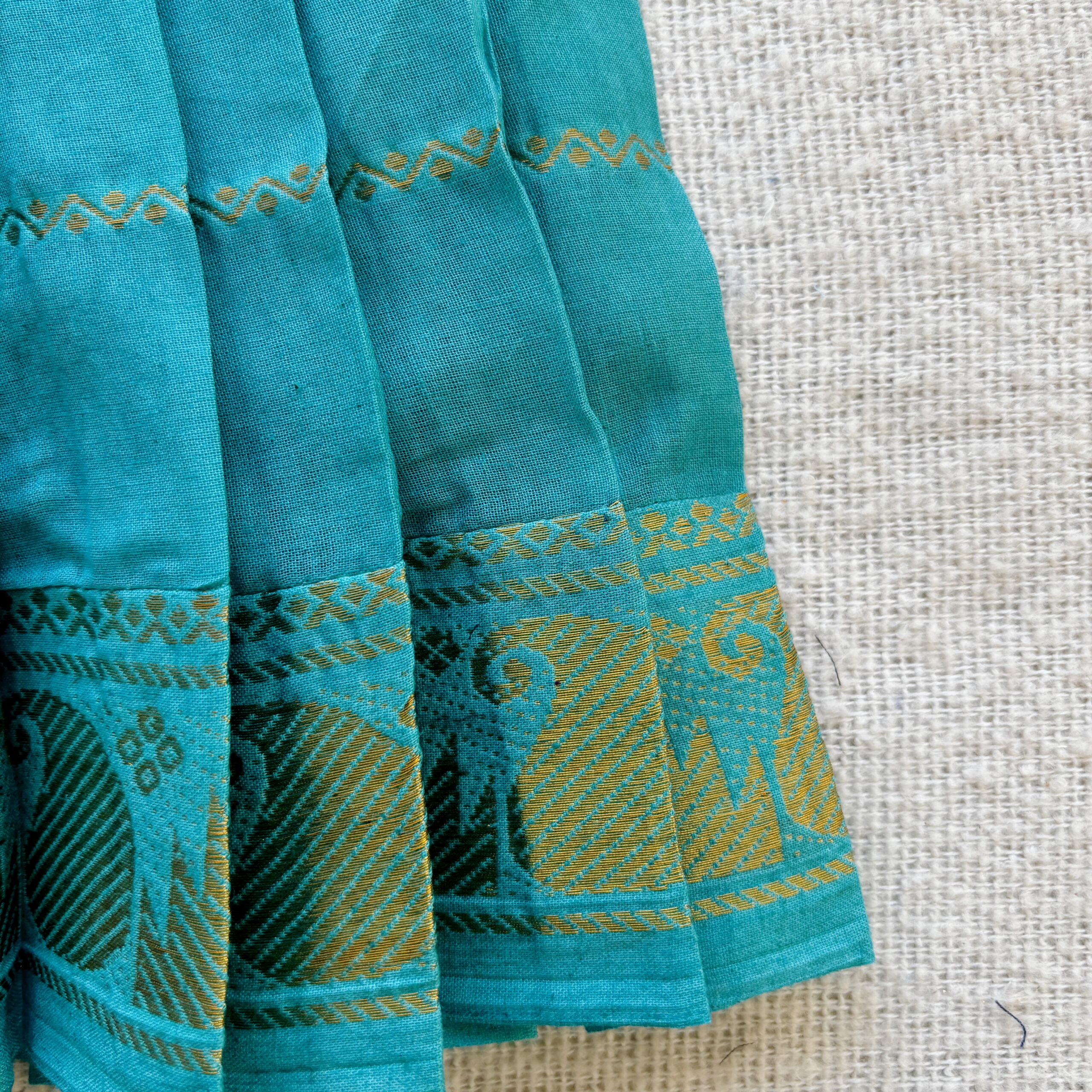 Traditional zari border detail of teal kids frock