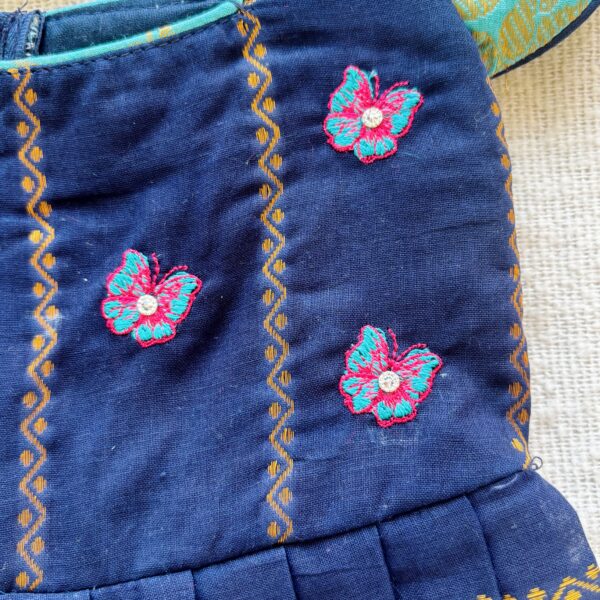 Close up embroidery work on kids festive frock