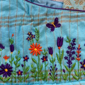 close up Floral embroidery on teal kids frock