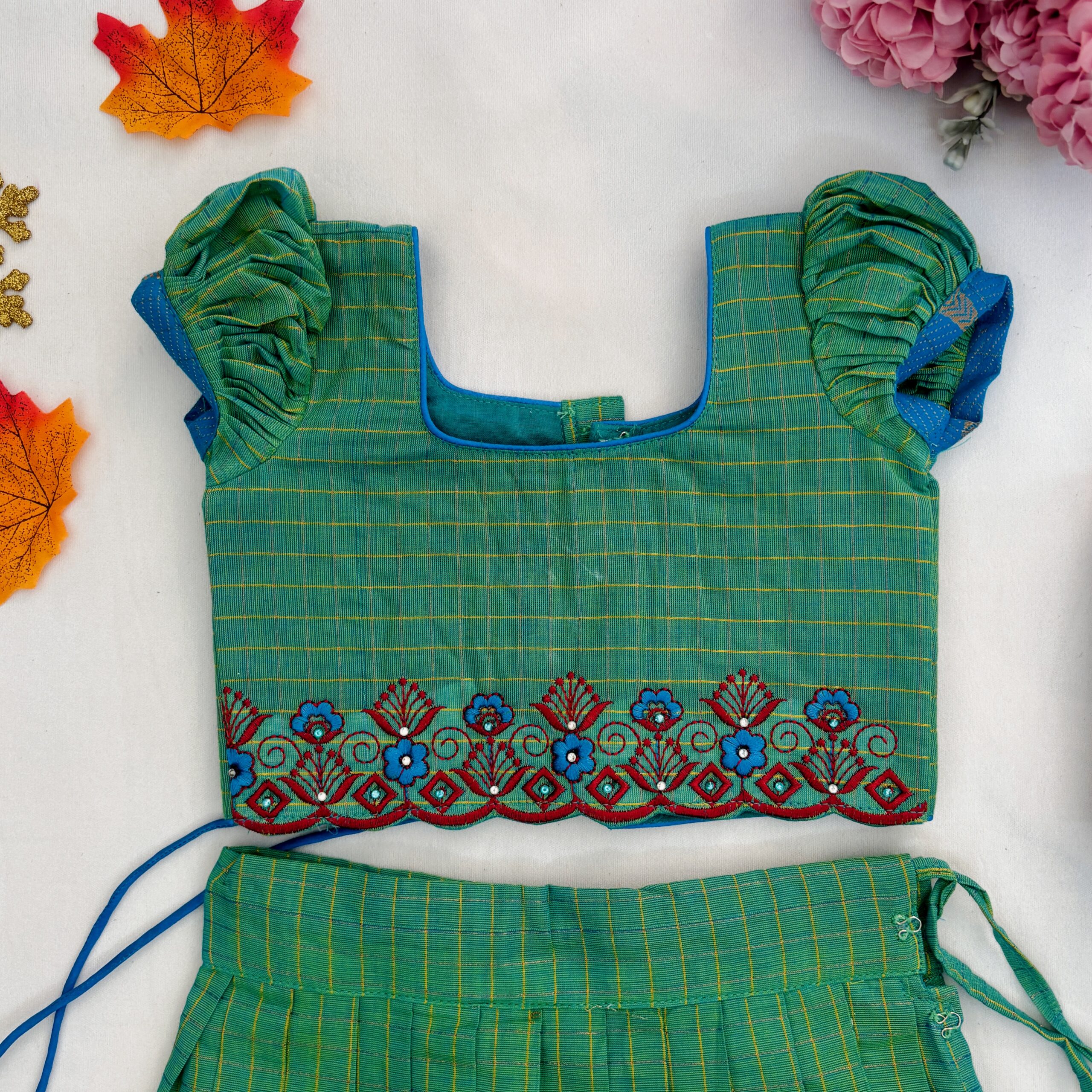 Top view embroidered neckline of green kids crop top