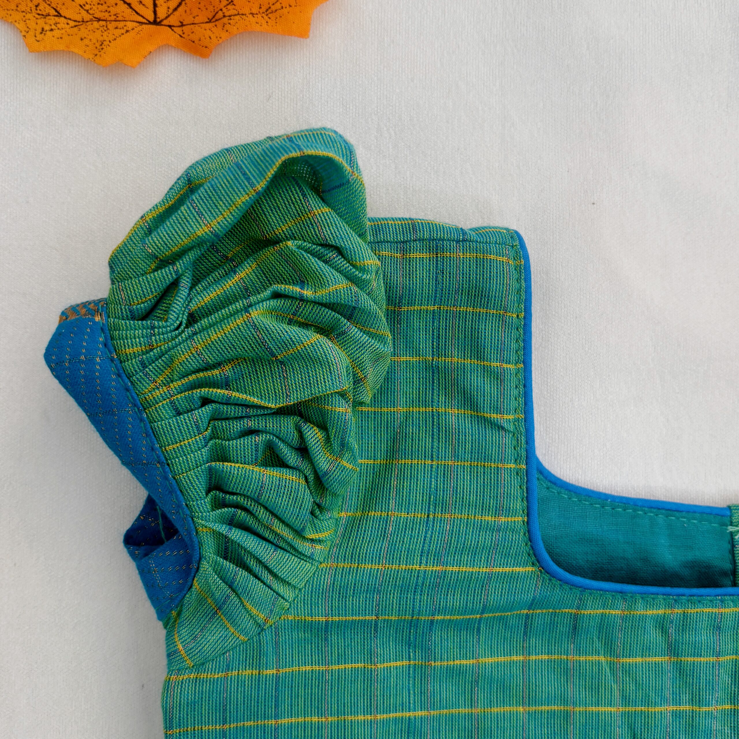 Sleeve detail of green embroidered kids crop top