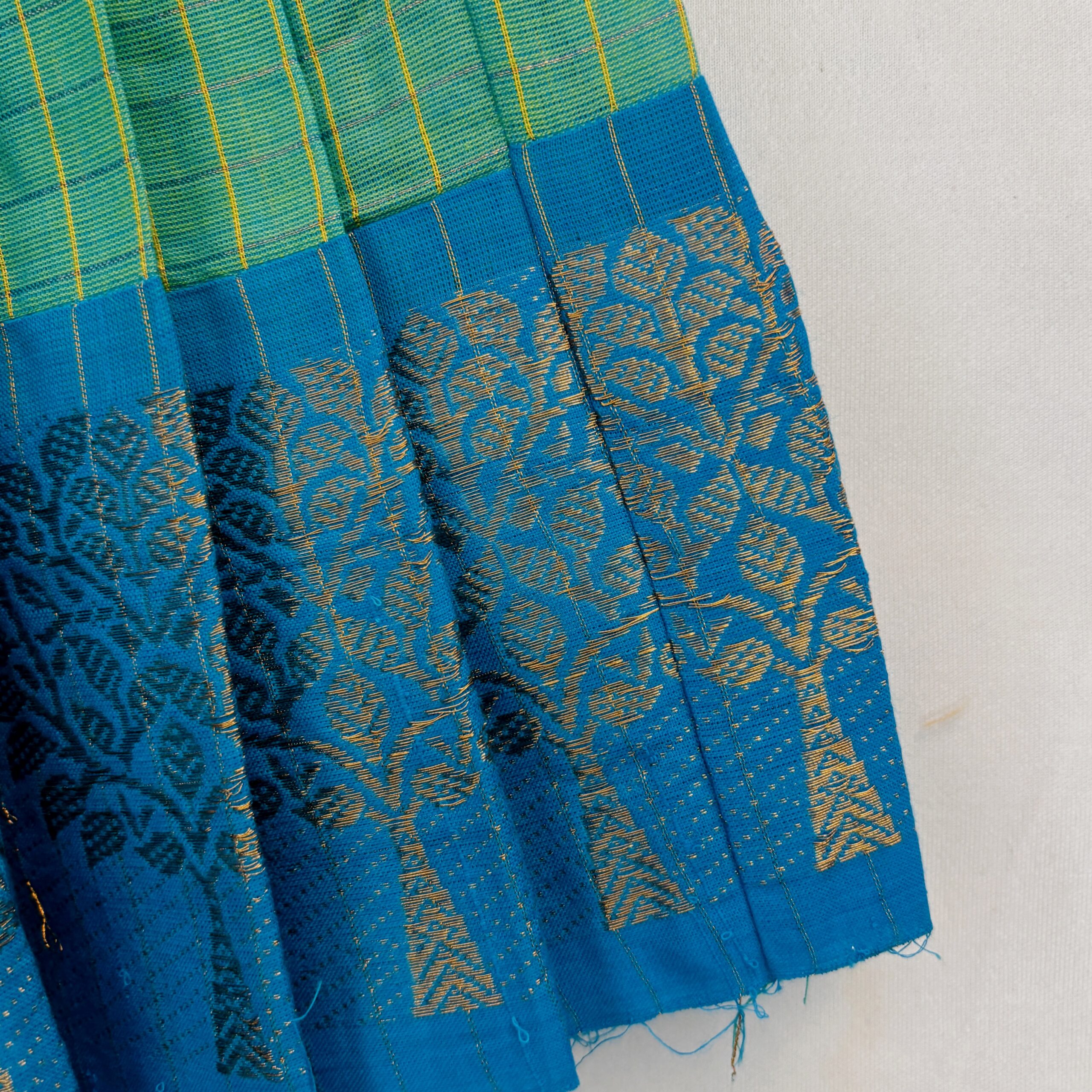 Blue border detail on green traditional kids skirt