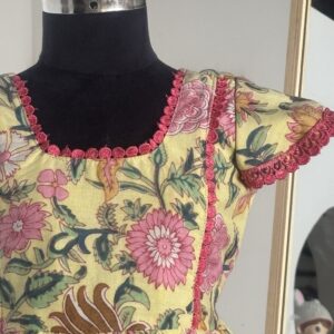 Front view of yellow floral cotton girls frock with gathered skirt