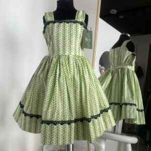 Green cotton girls frock with leafy block print and black lace detailing by Varna Design Wear