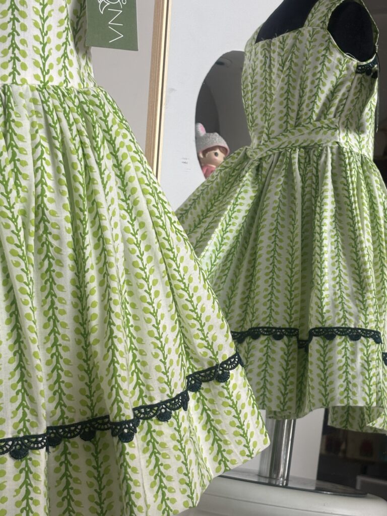 Green cotton girls frock with black lace border detail