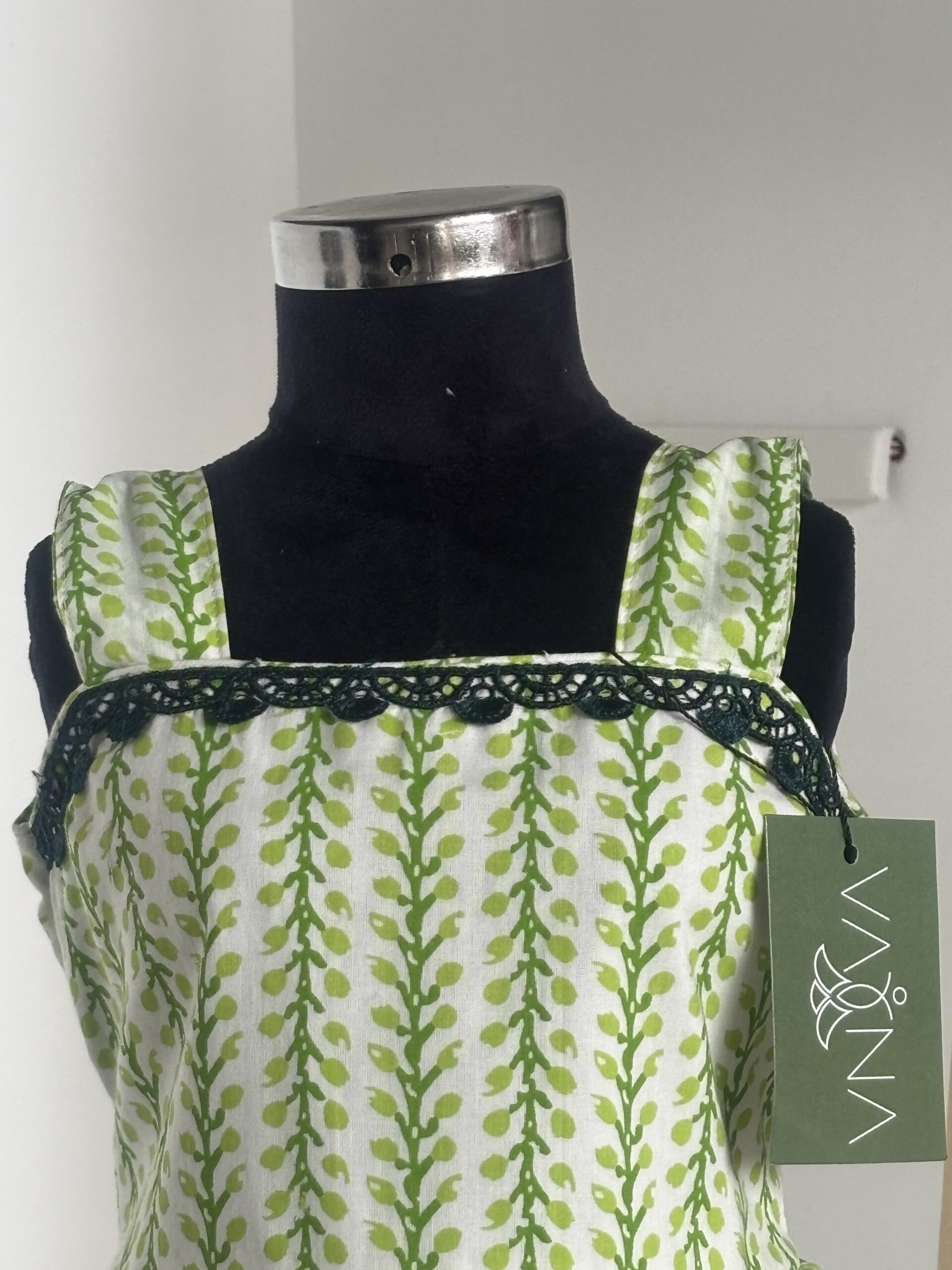 Front view of green cotton girls frock with square neckline
