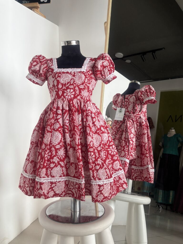 Red cotton girls frock with white floral block print and puff sleeves by Varna Design Wear