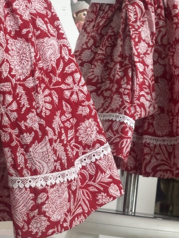 Red cotton girls frock with floral print and white lace border