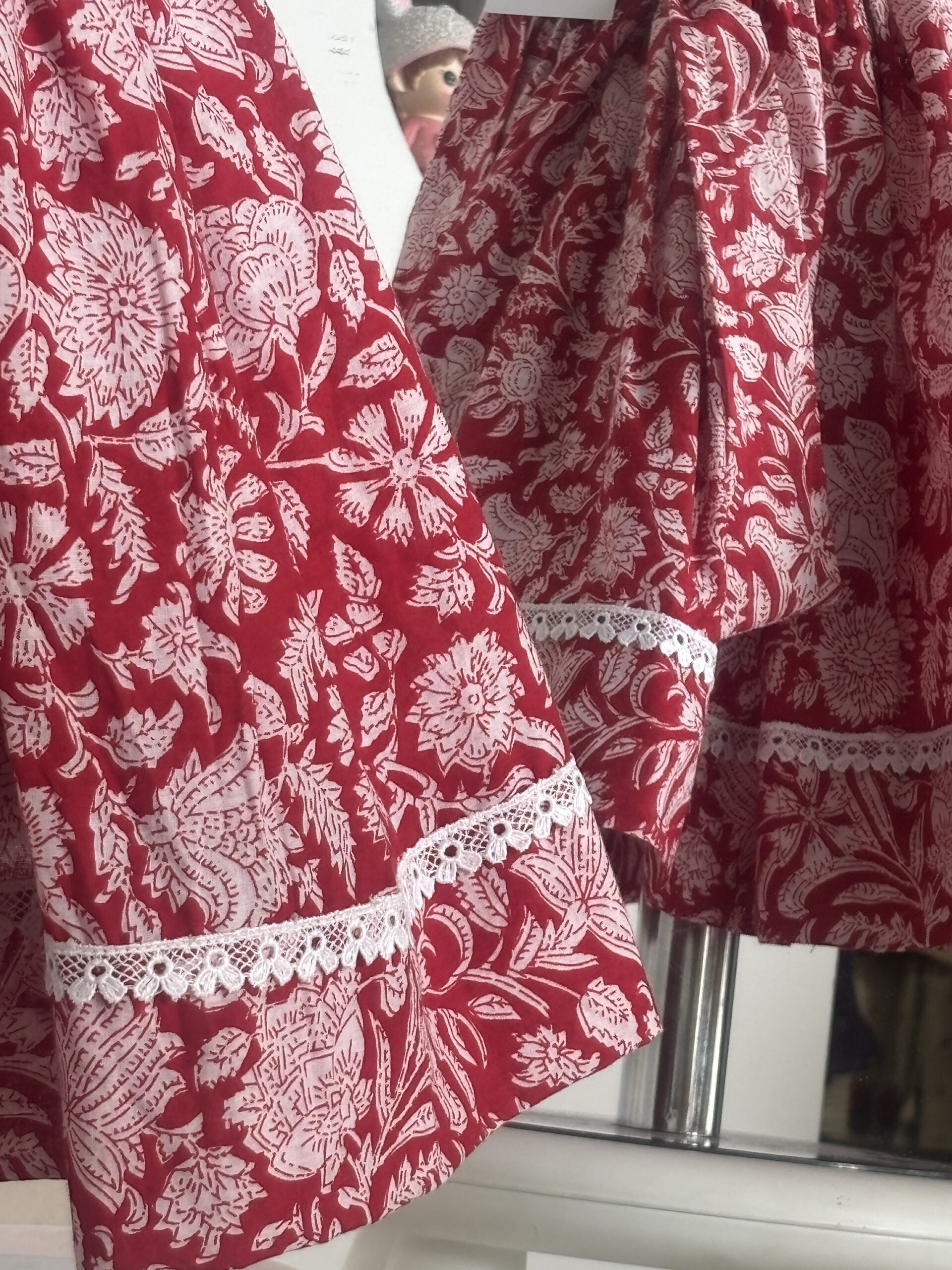 Red cotton girls frock with floral print and white lace border