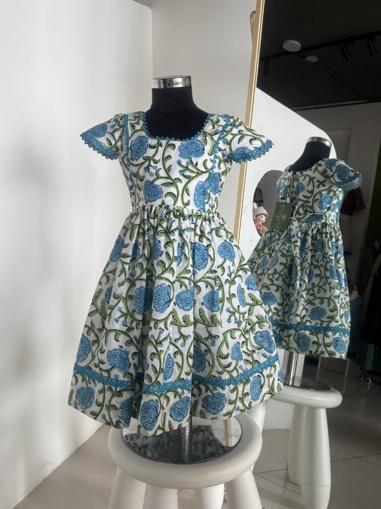 Blue cotton girls frock with floral hand block print and flutter sleeves by Varna Design Wear