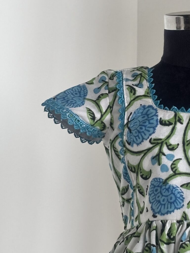 Front view of blue floral cotton frock for girls with gathered skirt
