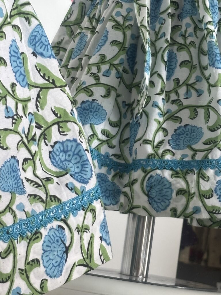 Blue cotton girls dress with floral print and lace border detail