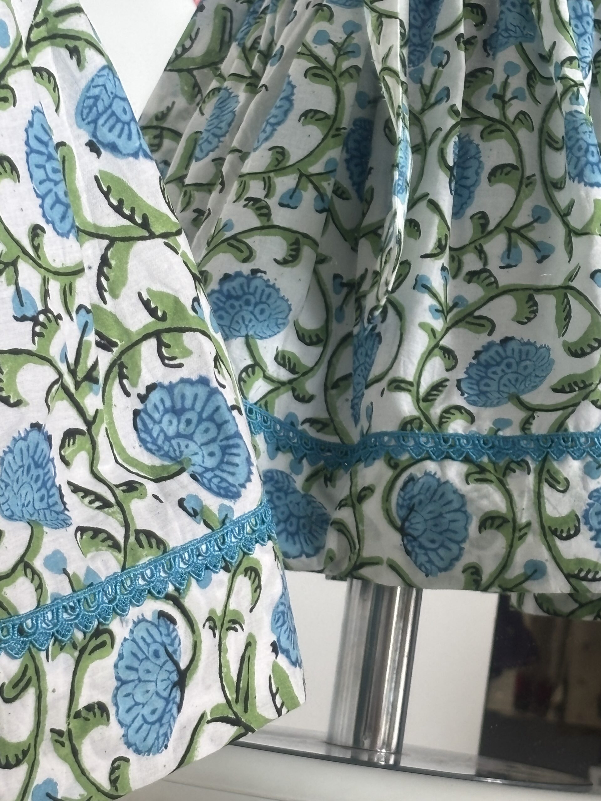 Blue cotton girls dress with floral print and lace border detail