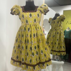 Yellow cotton girls frock with traditional print by Varna Design Wear