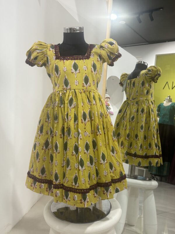 Yellow cotton girls frock with traditional print by Varna Design Wear