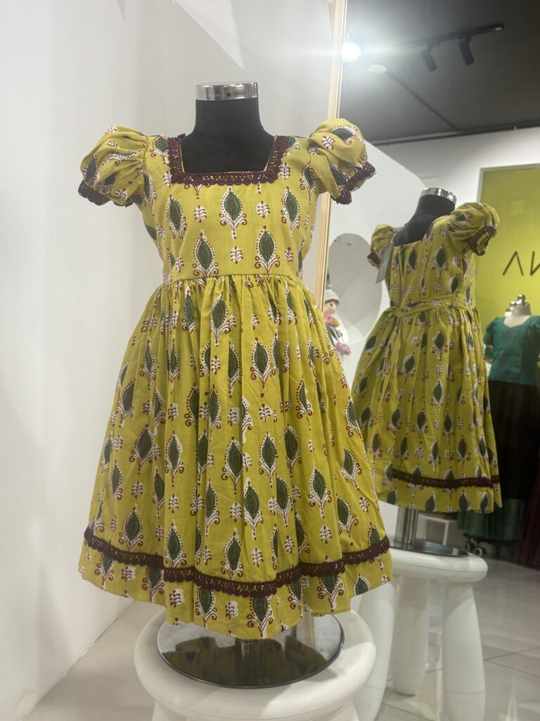 Yellow cotton girls frock with traditional print by Varna Design Wear