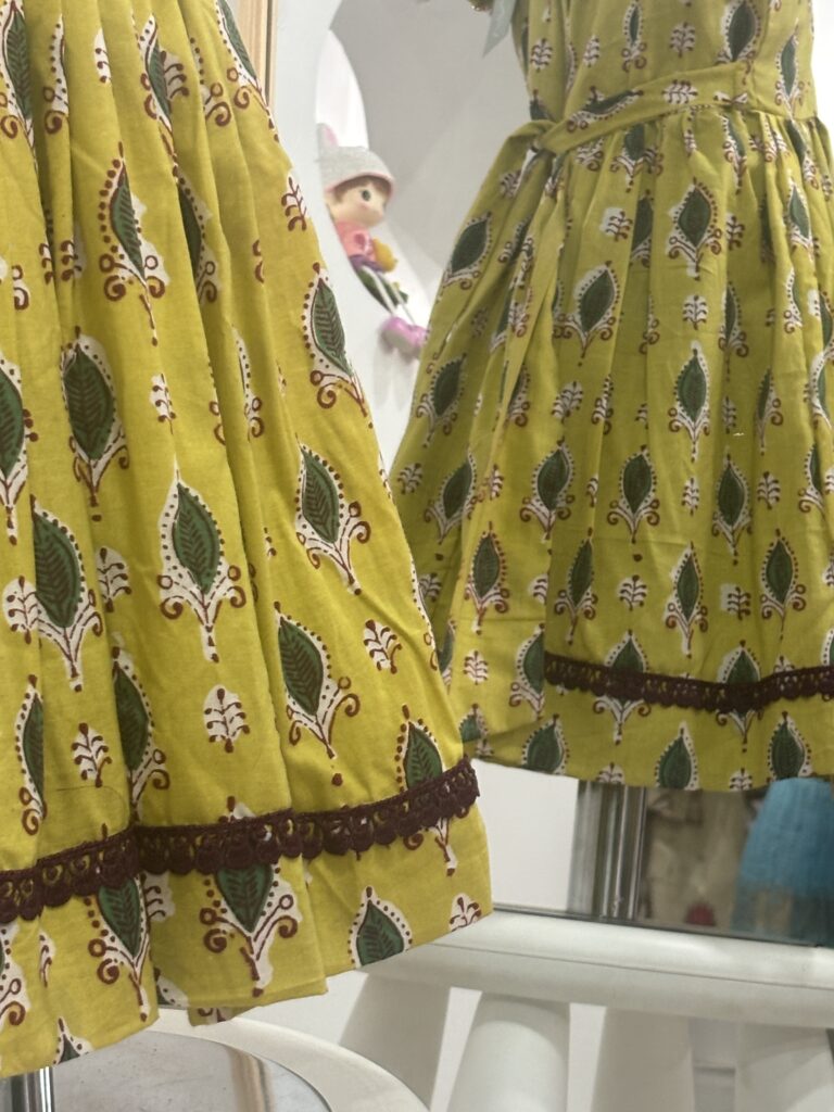 Yellow cotton girls frock with decorative lace detail