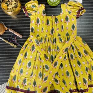 yellow girls frock with puff sleeves and lace border