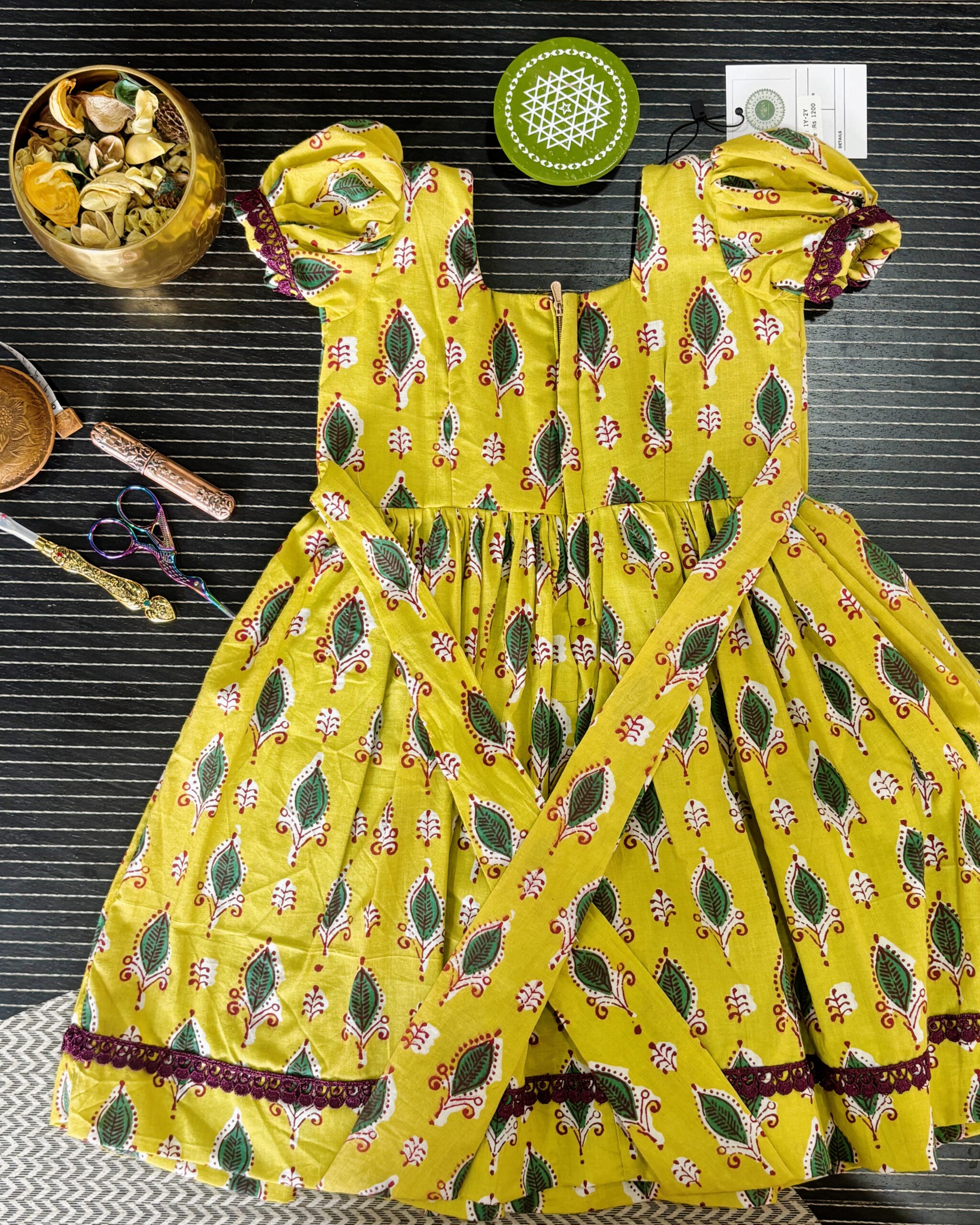 yellow girls frock with puff sleeves and lace border