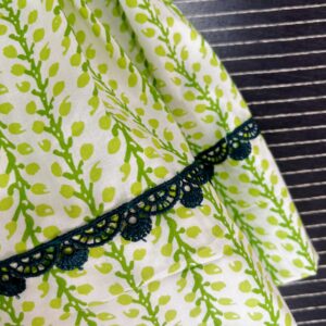 Layered green printed cotton frock with lace detailing