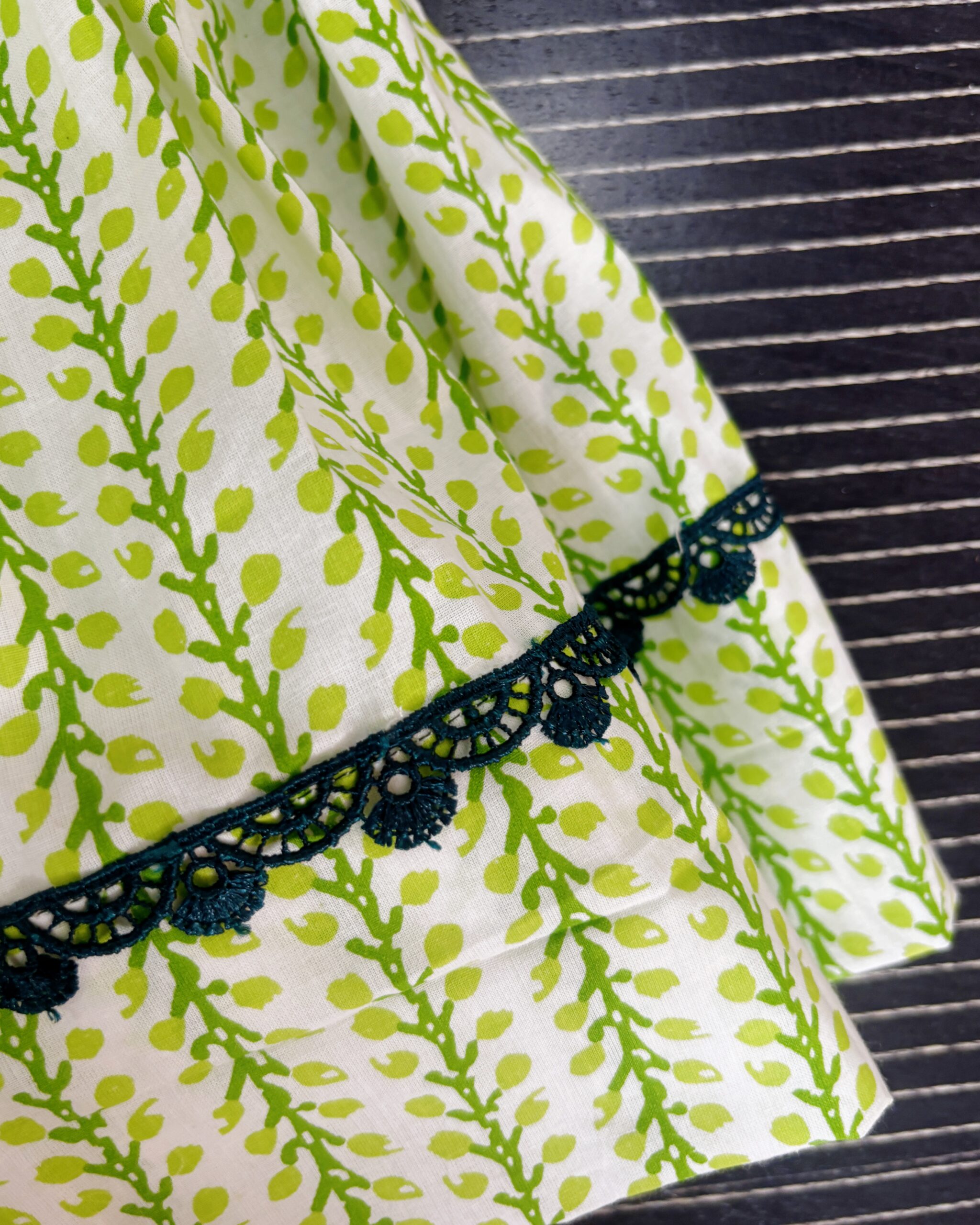 Layered green printed cotton frock with lace detailing