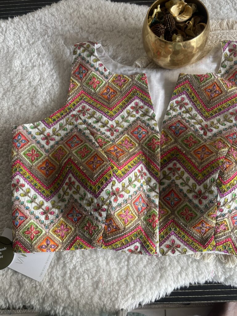 White designer print sleeveless blouse