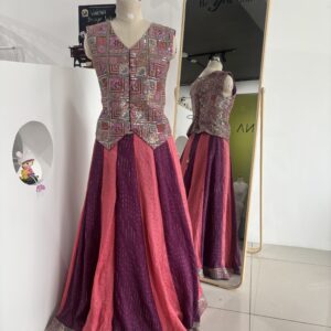 Purple and peach designer panel lehenga with sleeveless jacket style blouse by Varna Design Wear