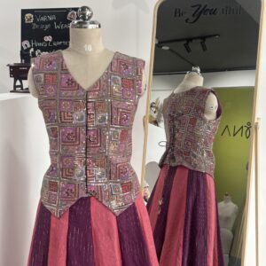Close-up of handcrafted designer work on purple jacket style blouse