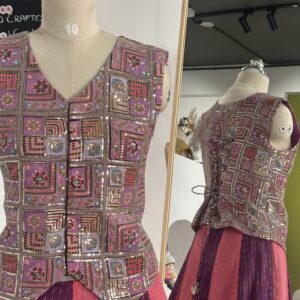 Purple and peach designer panel lehenga with sleeveless jacket style blouse by Varna Design Wear