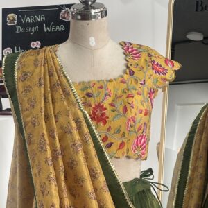 Close-up of floral blouse with olive green lehenga and printed dupatta