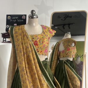 Olive green designer lehenga with floral printed blouse and yellow crush tissue dupatta by Varna Design Wear