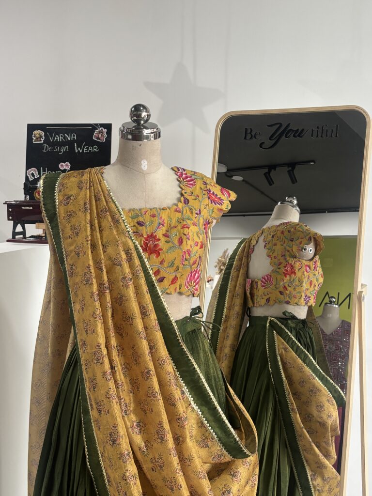 Olive green designer lehenga with floral printed blouse and yellow crush tissue dupatta by Varna Design Wear