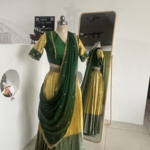 Bottle green and lemon yellow half saree set with embroidered blouse by Varna Design Wear