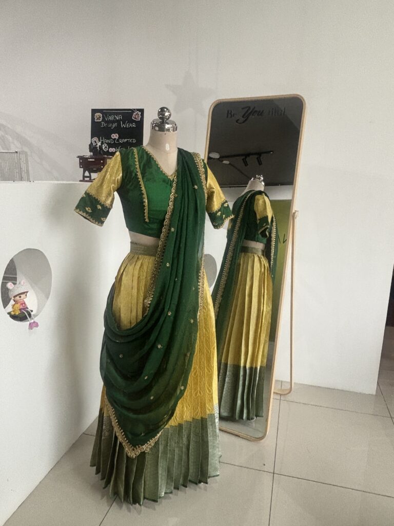 Bottle green and lemon yellow half saree set with embroidered blouse by Varna Design Wear
