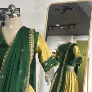 Lemon yellow brocade lehenga skirt with bottle green zari border